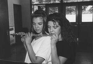 two girls playing flute har har